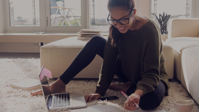 Woman in living room with laptop