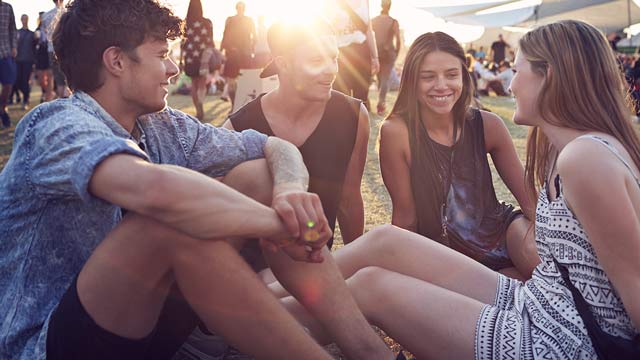 Young people sitting outdoors.