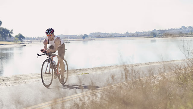 Triathlete man bicycling small image
