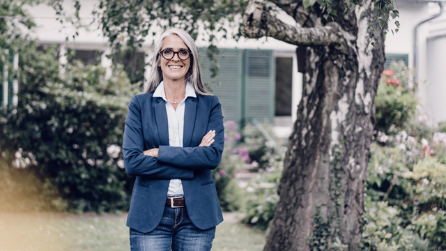 Woman smiling under tree