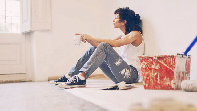 Woman taking a break from painting small overlay