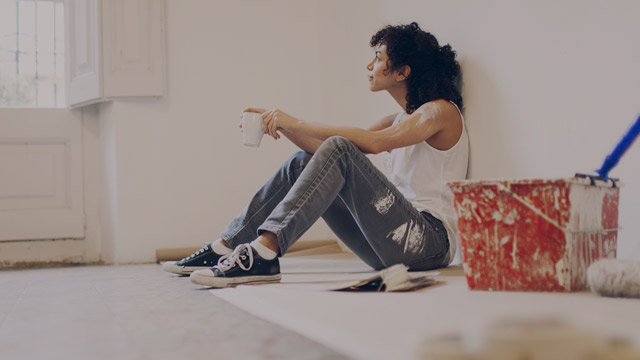 Woman taking a break from painting small overlay