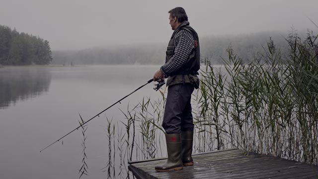 senior man fishing from bridge small overlay