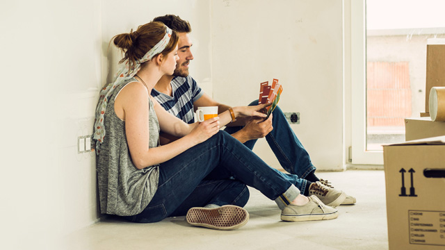 Ccouple sittig in livingroom close to moving boxes 