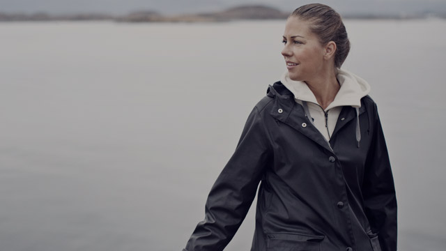 woman in raincoat on boat small overlay